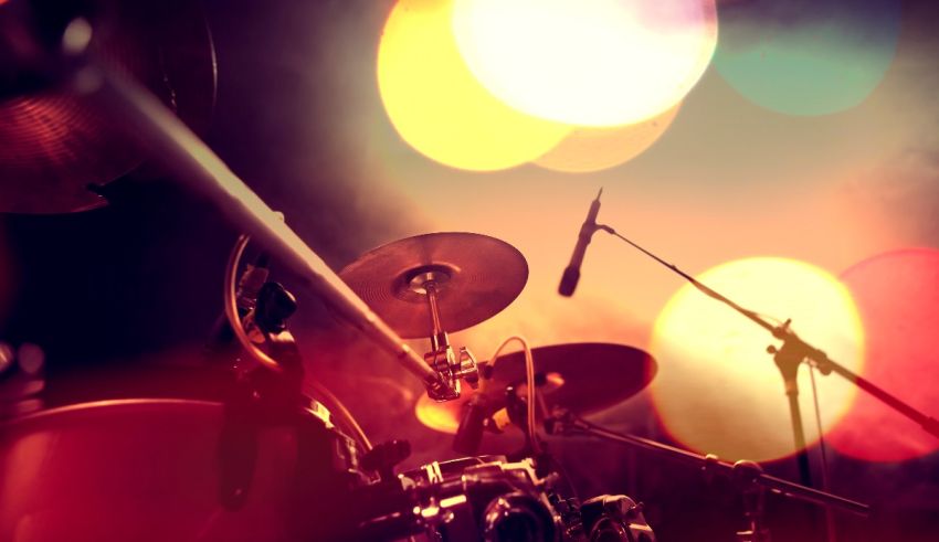 A close up of a drum set in a dark room.