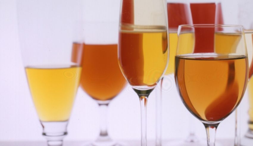 A group of glasses filled with different types of wine.