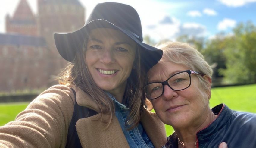 Two women taking a selfie in front of a castle.