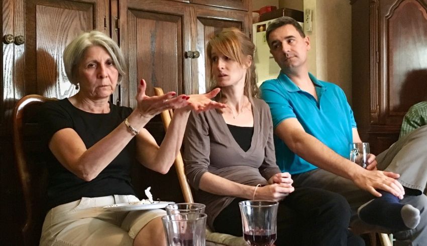A group of people sitting around a table and talking.