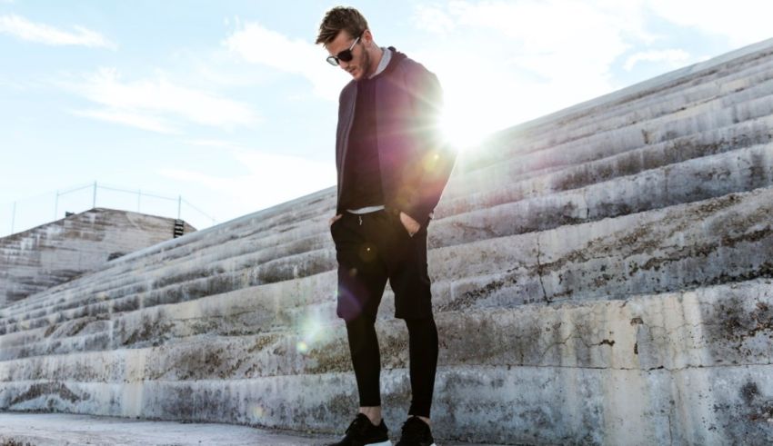 A man standing on a set of steps with the sun behind him.