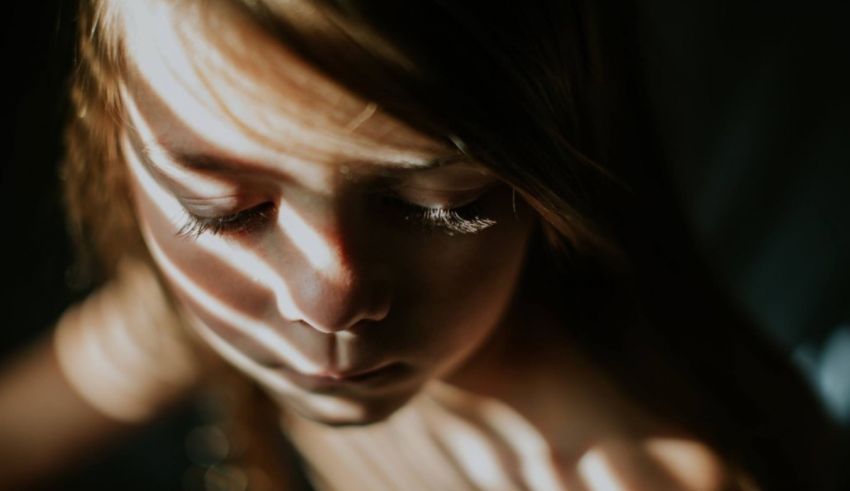 A close up of a girl with her eyes closed.