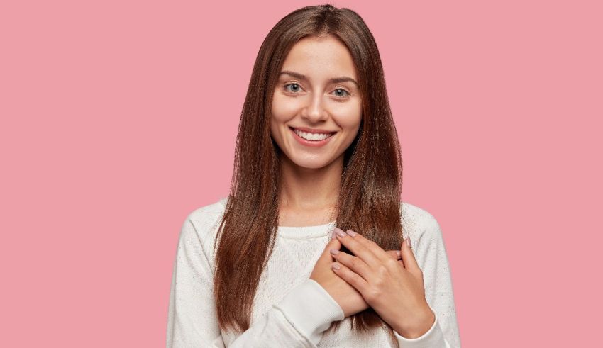 A young woman with long brown hair posing for a photo.