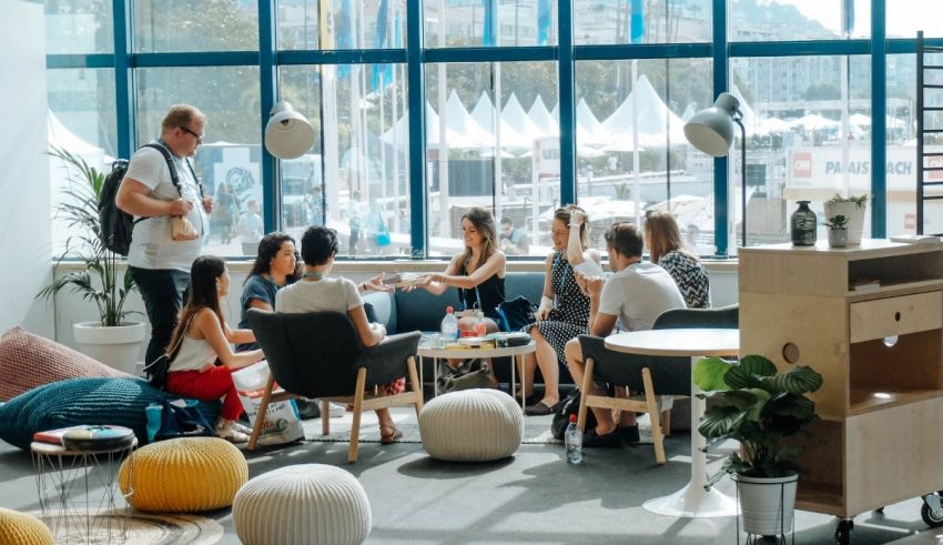 A group of people sitting around a table in an office.