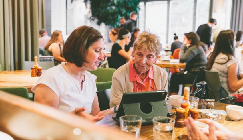 A group of people sitting at a table in a restaurant.