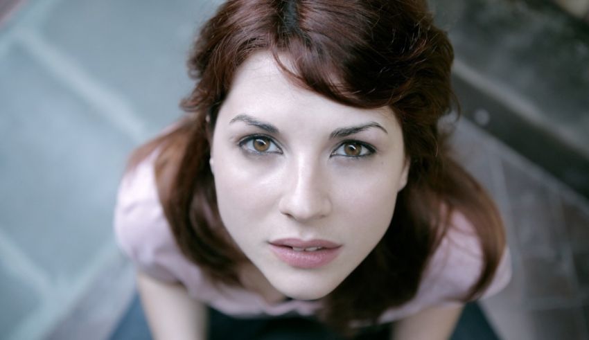 A woman with red hair is posing for a picture.