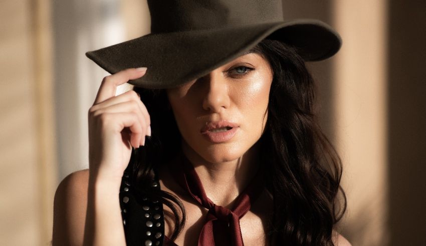 A woman in a hat is posing for a photo.