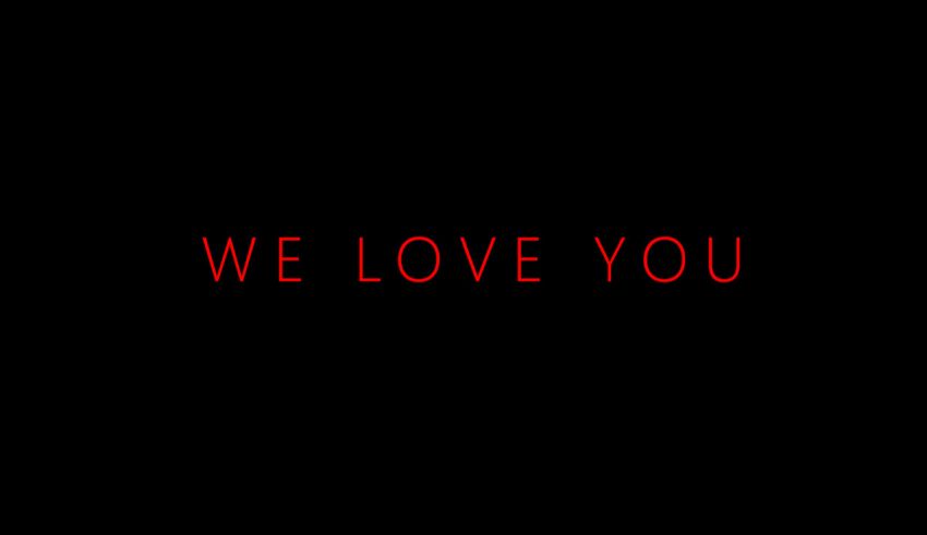 A black background with the words we love you on it.