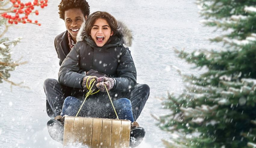 Two people riding a sled down a snowy hill.