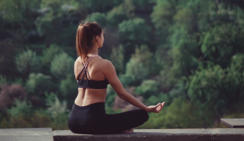 A woman is meditating in a lotus position.