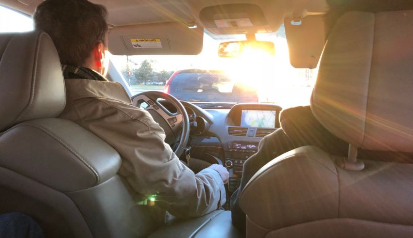 Two people sitting in the back seat of a car.
