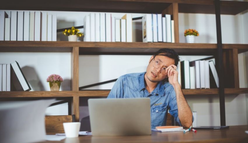 A man sitting at a desk with a laptop.