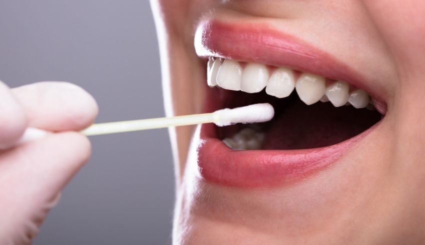 A woman is brushing her teeth with a toothbrush.