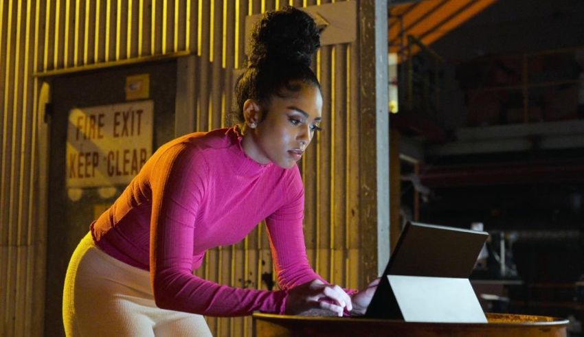 A woman using a laptop in a dark room.