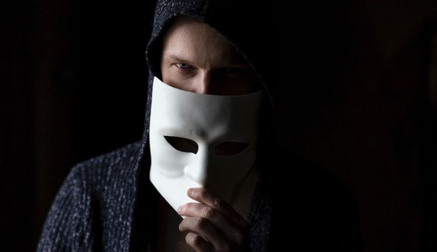 A man with a white mask covering his face.