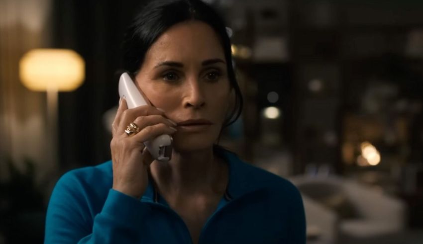 A woman talking on a cell phone in a living room.