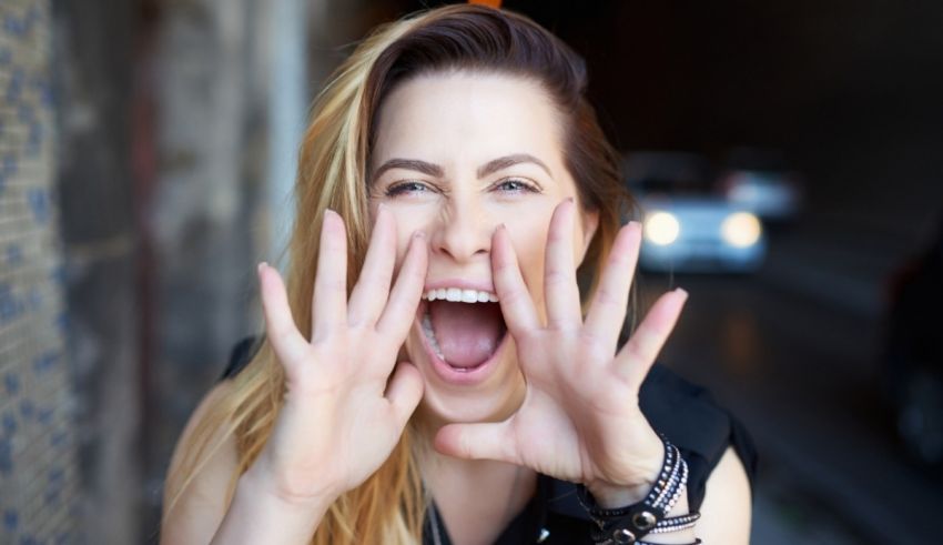 A woman is making a face with her hands.