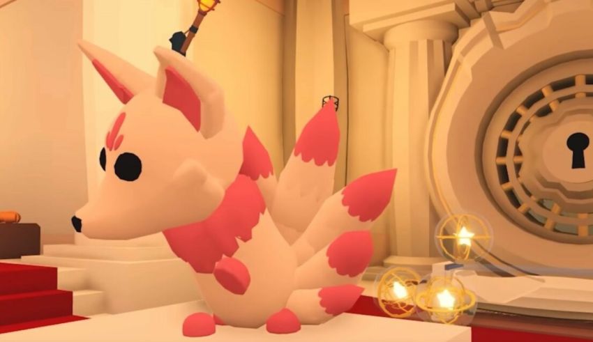 A pink and white stuffed animal is sitting on a table.