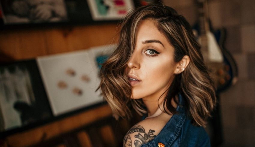 A woman with a tattoo on her shoulder.