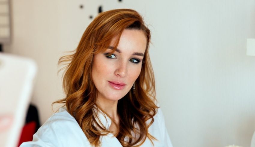 A woman is taking a selfie in front of a mirror.