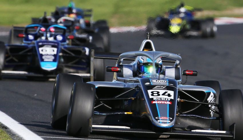A group of racing cars on a race track.