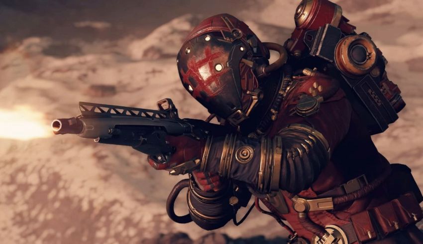 A man with a gun in front of a mountain.