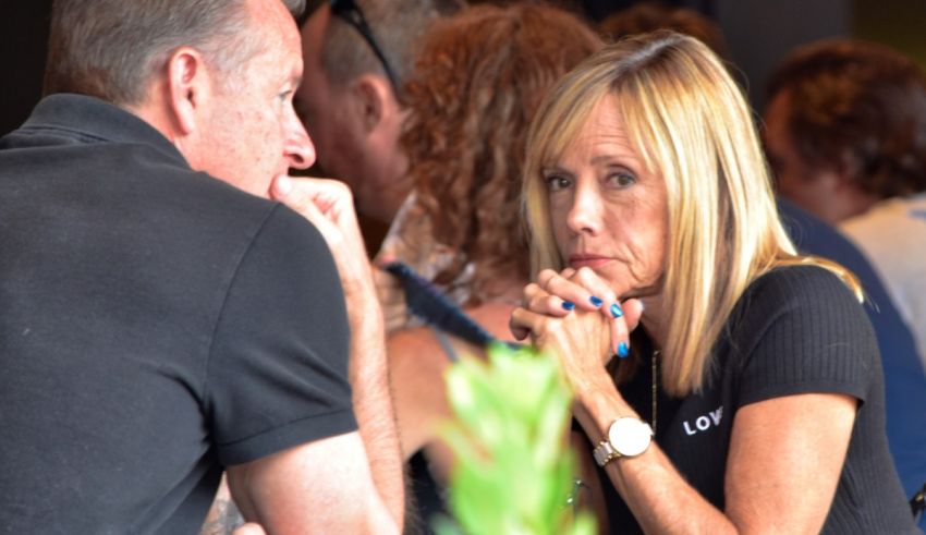 A man and woman talking to each other at an event.