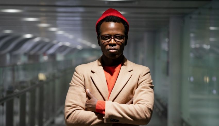 A man in a red hat standing in a hallway.