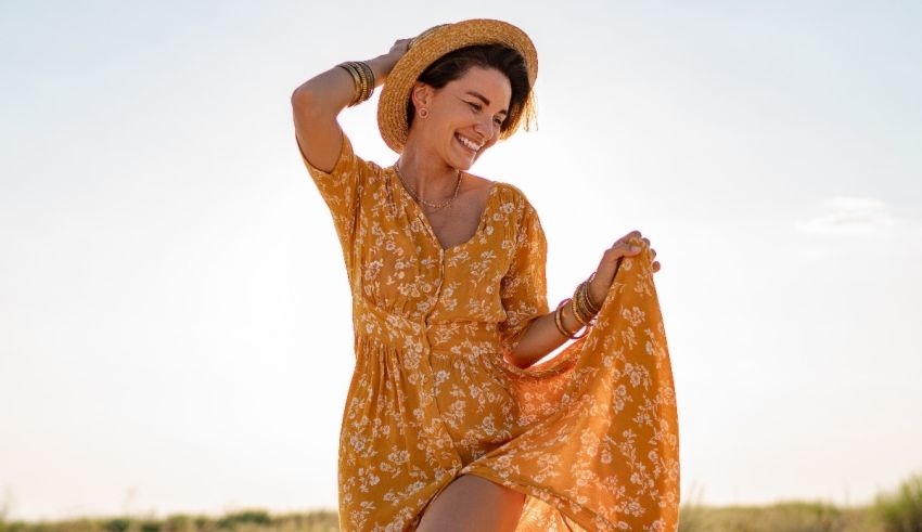 A woman in a yellow dress standing in a field.