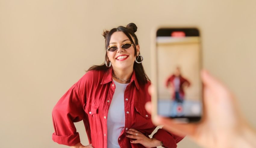 A woman is taking a selfie with her phone.