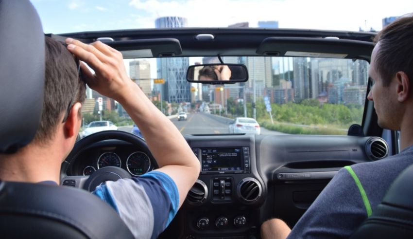 Two men sitting in the back seat of a car.