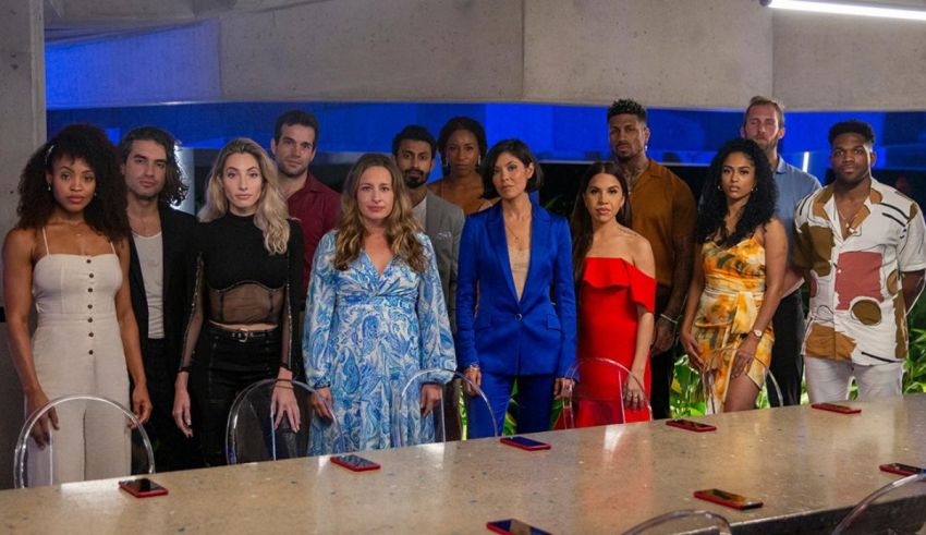 A group of people standing in front of a table.