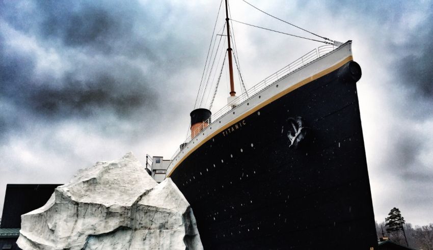 A ship next to a large rock.