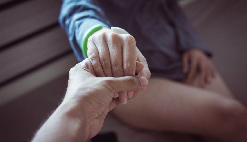 A man is holding a woman's hand.