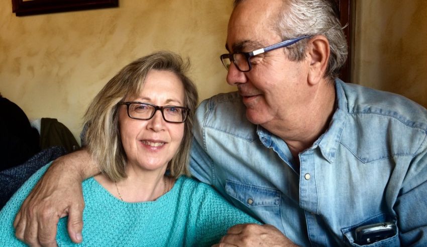 An older man and woman smiling for the camera.