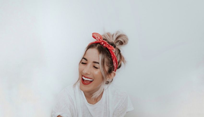 A smiling woman wearing a red bandana.