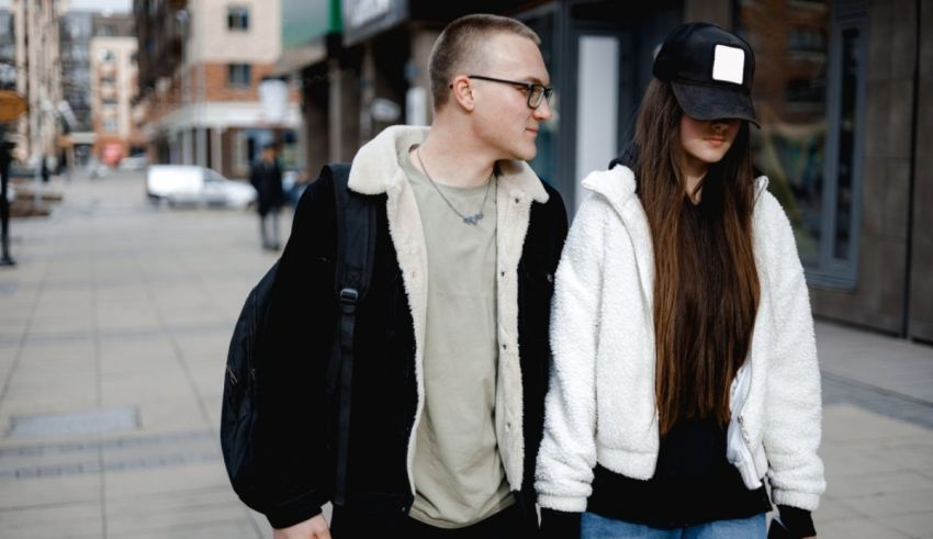 A young couple walking down a city street.