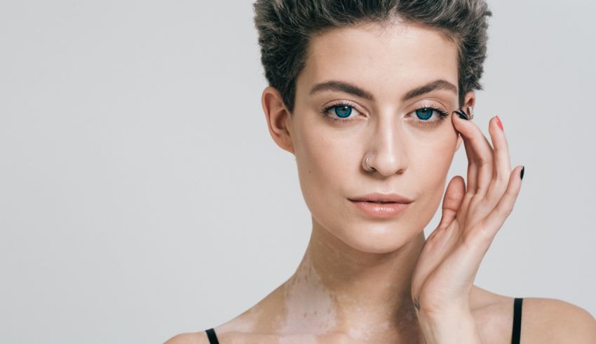 A woman is posing with her hand on her face.