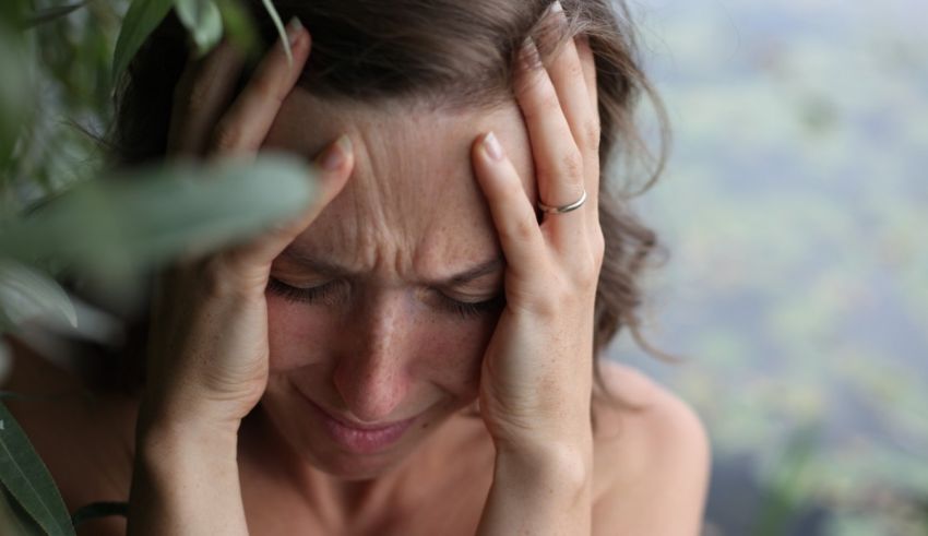 A woman with her hands on her head.