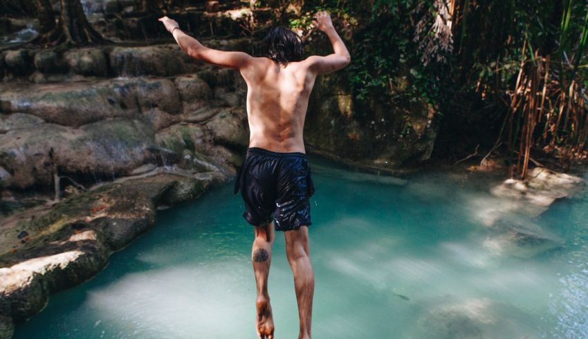 A man jumping into a pool in thailand.