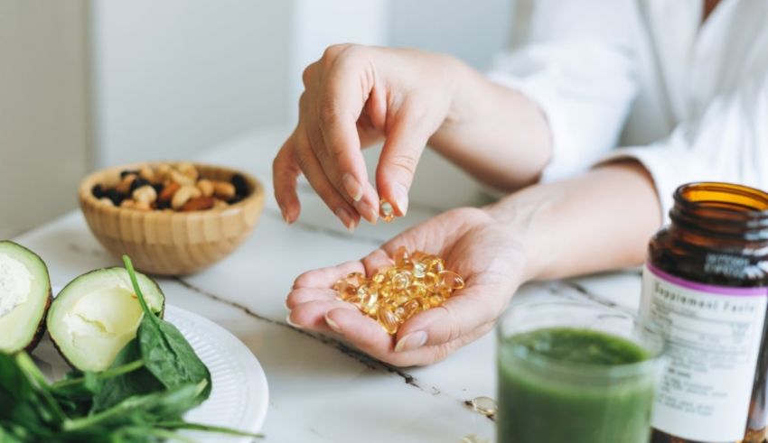 A woman is putting some greens on a plate.