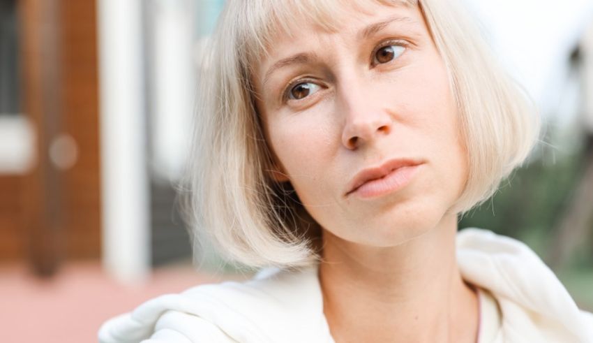 A woman with blond hair is looking at something.