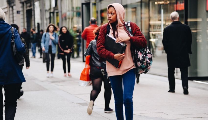 A woman walking on a sidewalk.