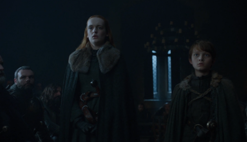 A group of people standing in a dark room.