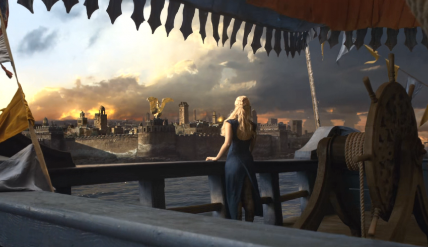 A woman is standing on the deck of a ship.