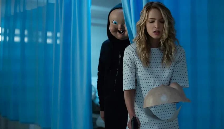 A woman in a hospital room with a mask on her head.