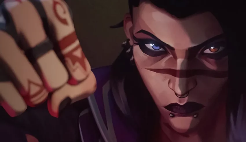 A woman with blue eyes is holding a fist.