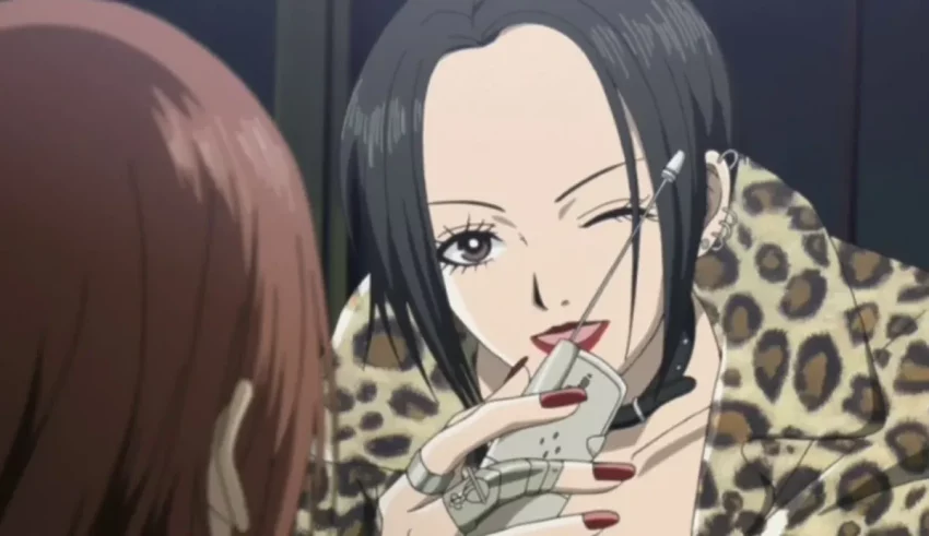 A woman in a leopard print coat is talking to another woman.