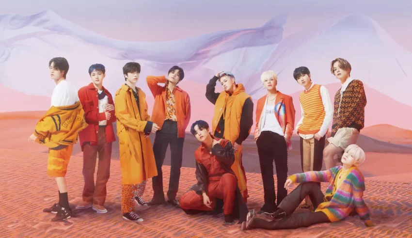 A group of bts members posing in front of a desert.