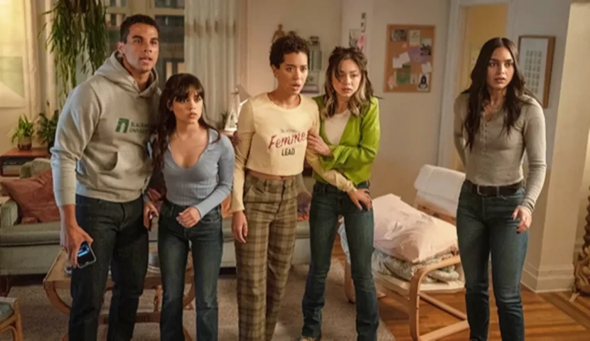 A group of people standing in a living room.